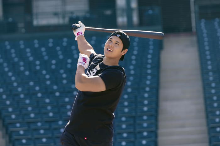 Shohei Ohtani swings a baseball bat.
